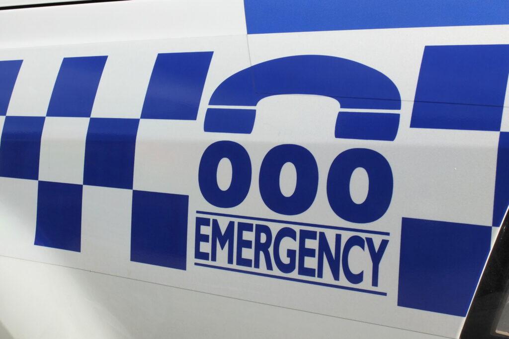 Melbourne, Australia April 24, 2017: Tripple zero numbers and blue and white sign on a police car